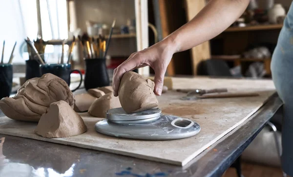 The Potter kneads a piece of clay with his hands and weighs it on the scales. — ストック写真