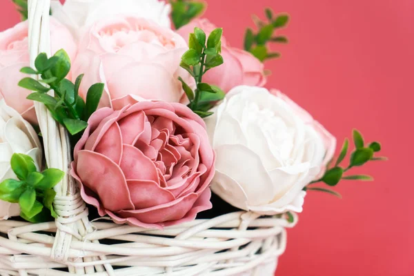 Flores en flor: Ramo de peonías rosas y blancas en una canasta de paja sobre un fondo rosa . —  Fotos de Stock