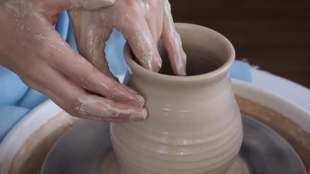 Girl Potter esculpe una jarra de arcilla en una rueda Potters . — Vídeos de Stock