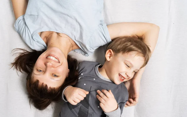 Family Time Mom Son Lying Bed Hugging Laughing Merrily Portrait — Stock Photo, Image