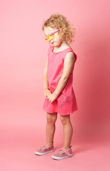 Pequeña Chica Rizada Gafas Divertidas Muestra Vestido Rosa Retrato Sobre — Foto de Stock