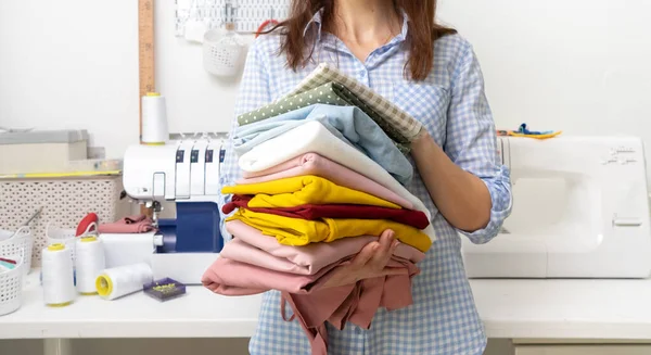 Sewing Girl Holds Her Hands Stack Multi Colored Fabrics Background — Stock Photo, Image