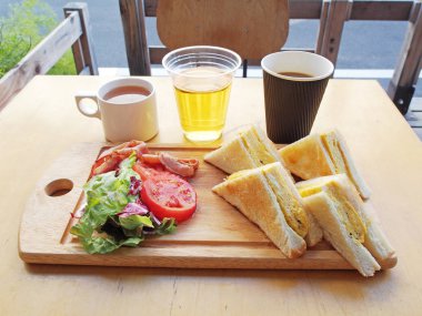  Omlet sandviç domates, salata ve ahşap tahta üzerinde pastırma ile    