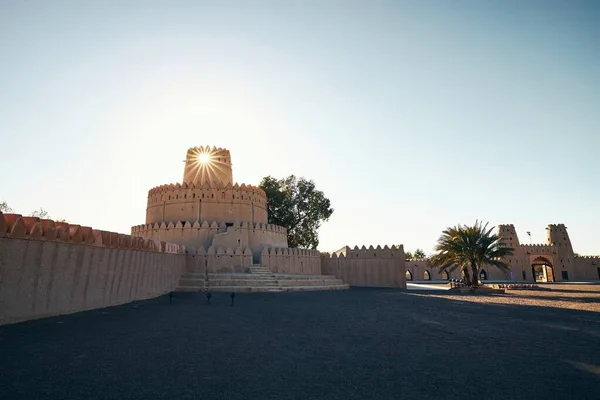 Historical landmark of United Arab Emirates. Al Jahili Fort in Al Ain at beautiful sunset.