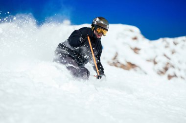 Male skier skiing at ski resort clipart