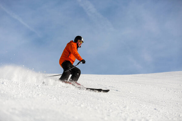 Male skier skiing on ski slope