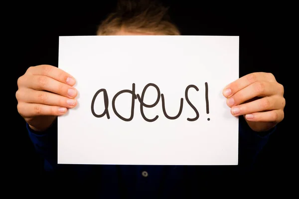 Dítě drží ceduli s portugalské slovo Adeus - Sbohem — Stock fotografie