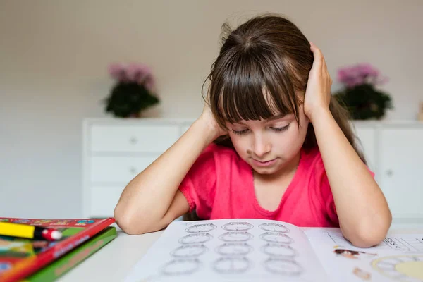 Разочарованная девушка с домашней работой — стоковое фото