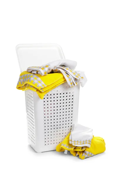 White plastic laundry basket with towel isolated on white backgr