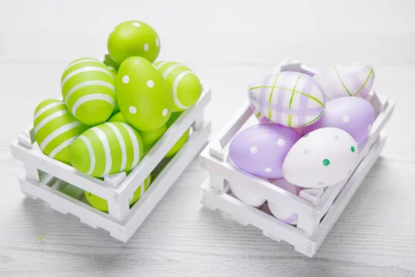 Top view of colorful easter eggs in white basket. Easter backgro — Stock Photo, Image