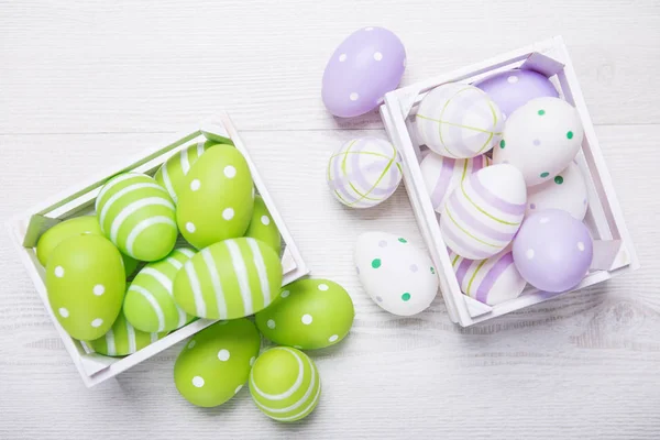 Top view of colorful easter eggs in white basket. Easter backgro — Stock Photo, Image