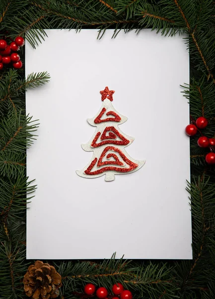 Creative layout made of Christmas tree branches with paper card — Stock Photo, Image