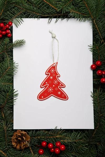 Creative layout made of Christmas tree branches with paper card — Stock Photo, Image