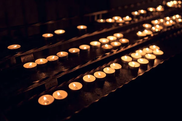 Many Small Tea Light Candles Glowing in the Church