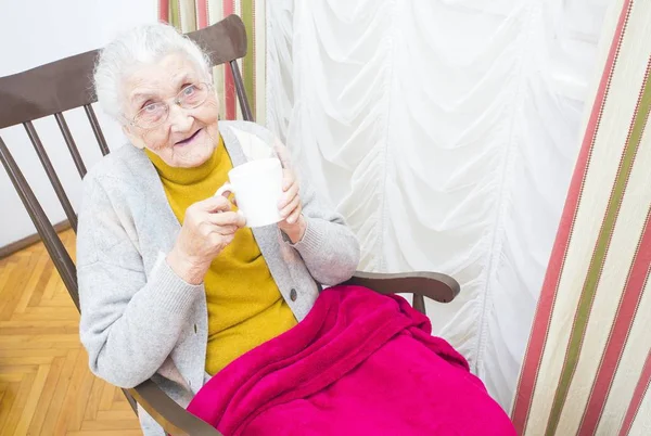 Elderly lady in chair — Stock Photo, Image