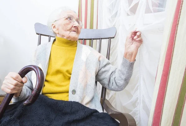 Elderly lady waiting for visitors — Stock Photo, Image
