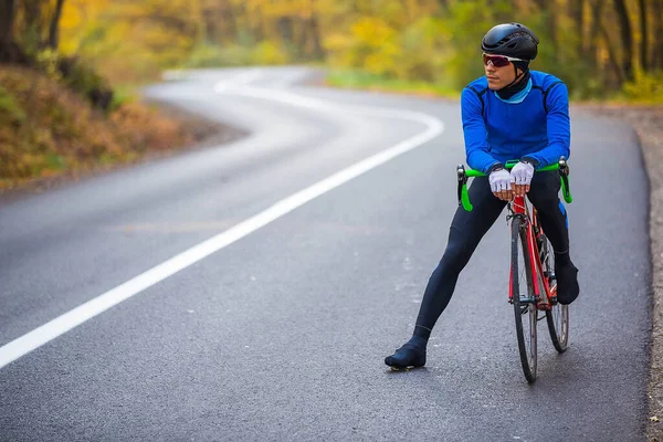 Young man in bikers clothes riding a racing bicycle — Stock Photo, Image