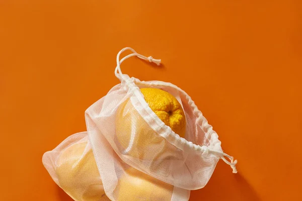 Zero waste concept. Eco bag with oranges. Bag Sewn from an old curtain. plastic is free, eco friendly concept.