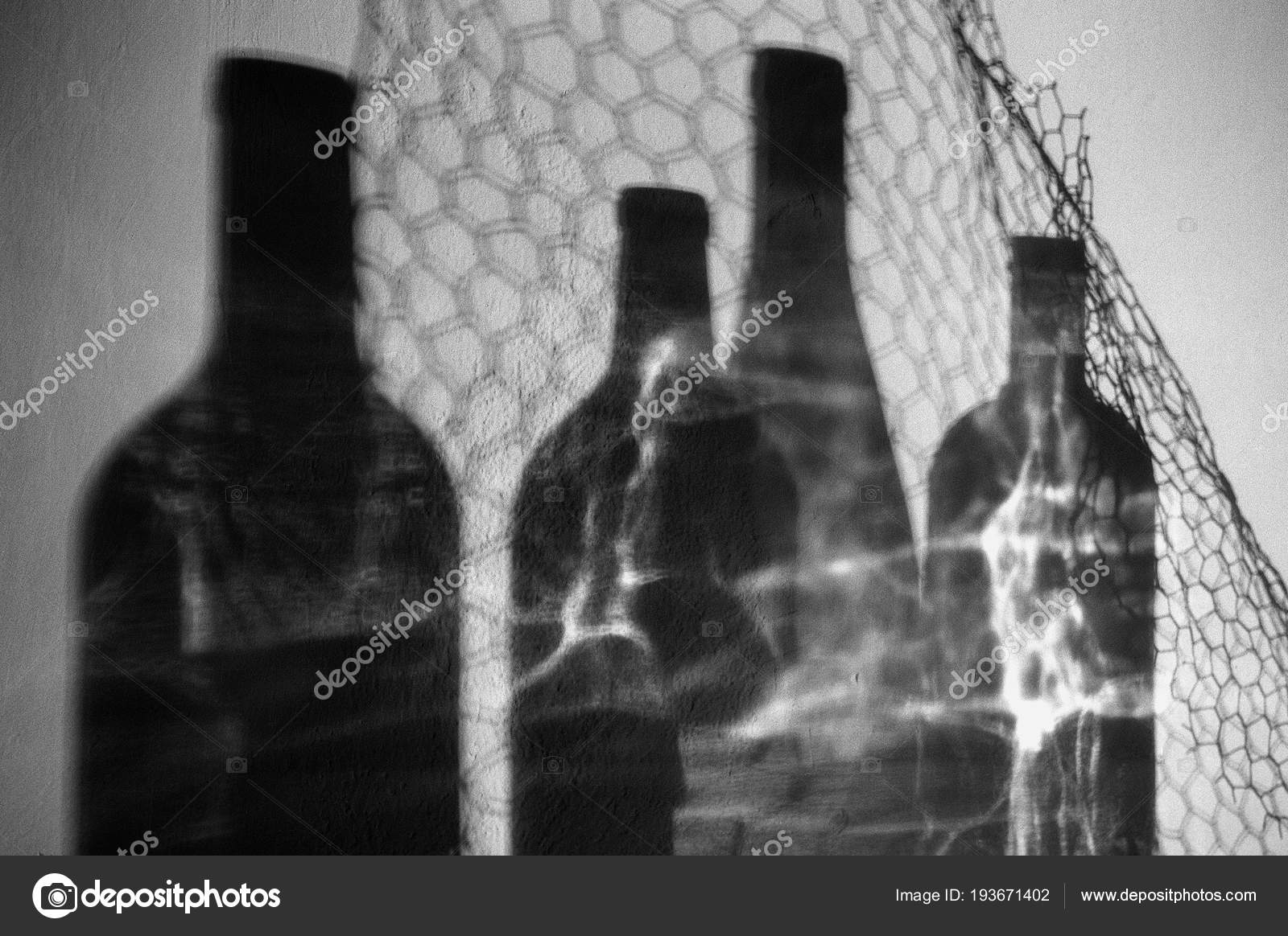 Black white artistic photography empty glass wine bottles shadows