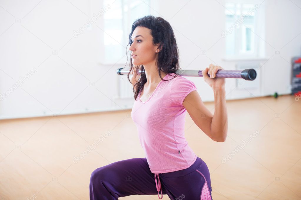 Fit woman exercising in fitness club 