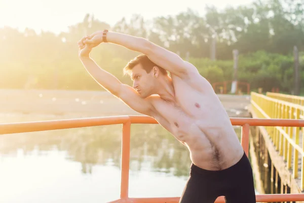 man doing side bend exercise.