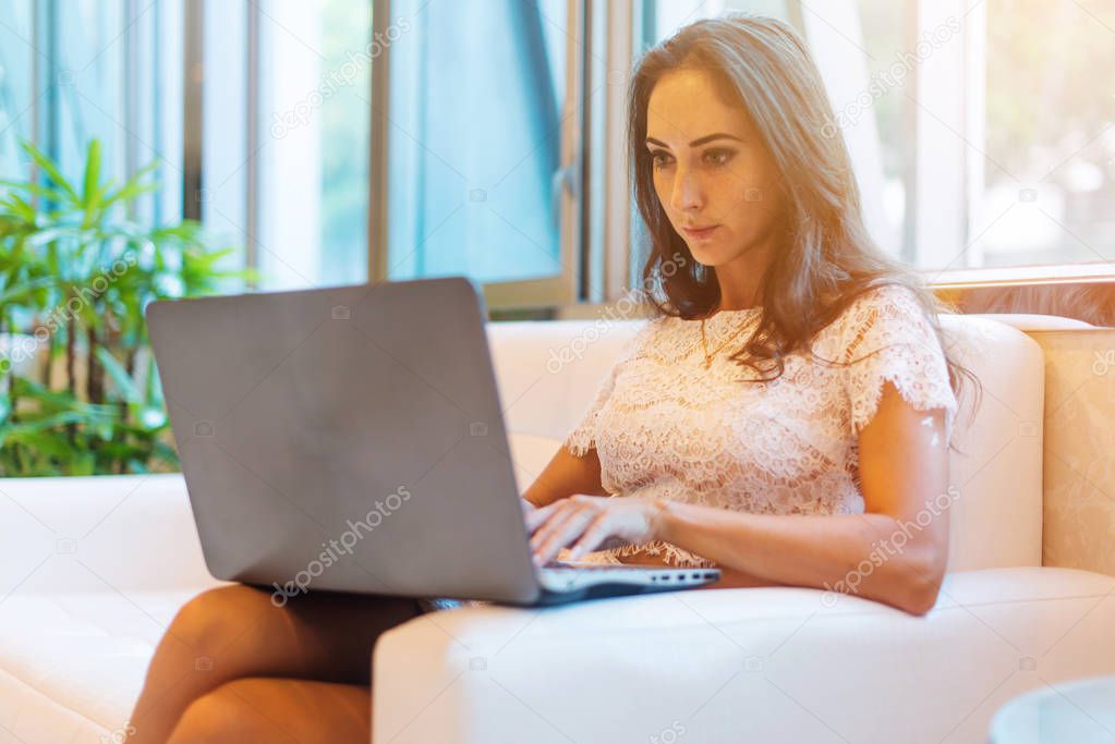 Concentrated good-looking woman using a laptop