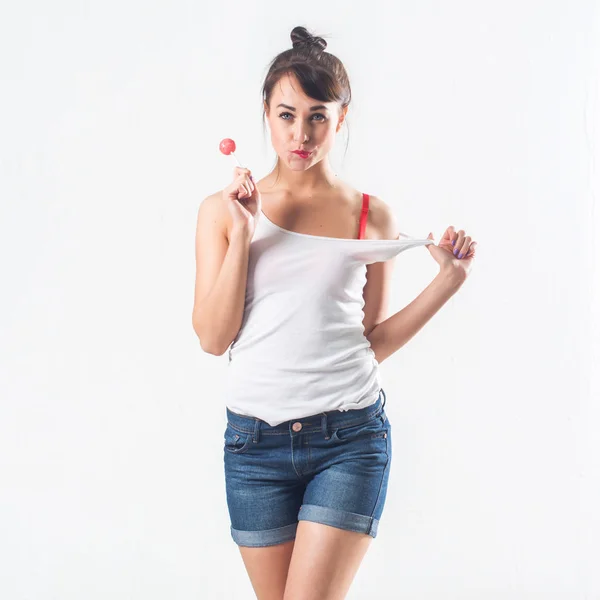 Young brunette model with lollipop — Stock Photo, Image