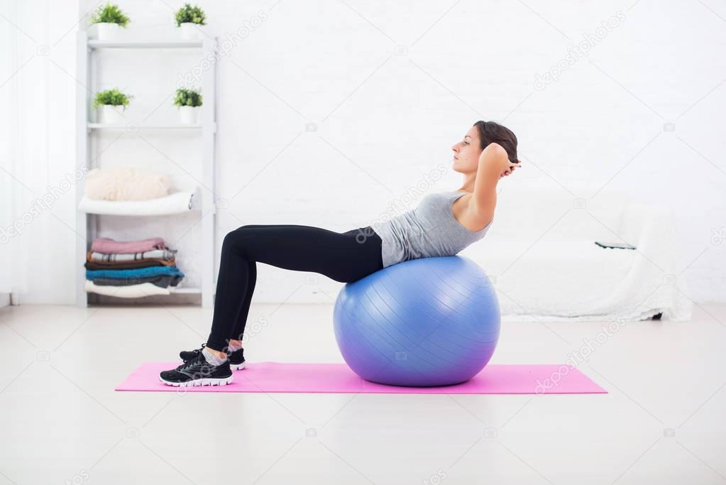 Fitness young woman doing abdominal crunches