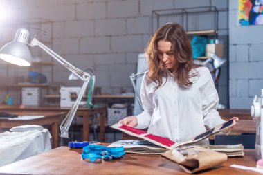 Genç kadın terzi katalog malzeme seçimi