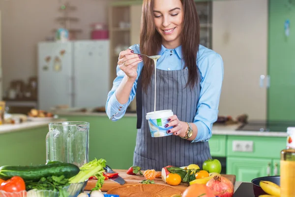 Cheerful young female chef cooking dessert — Stock Photo, Image