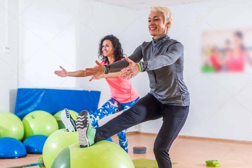 Two women doing exercises in aerobics class