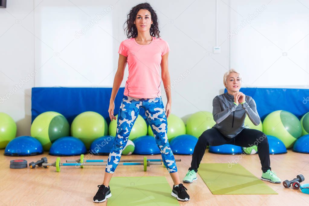 Two women doing exercises in aerobics class