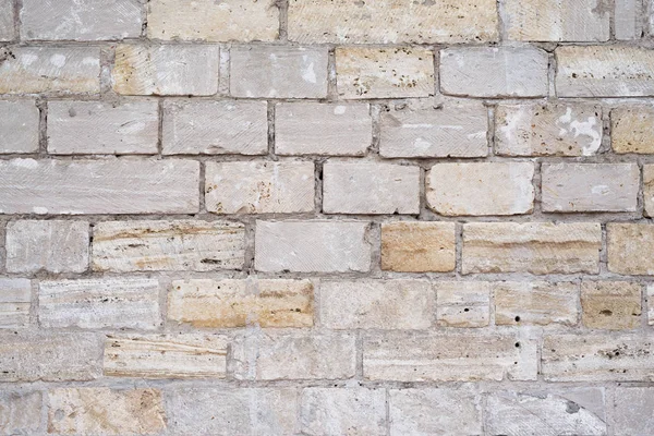 Part of a uneven stone wall with cement — Stock Photo, Image