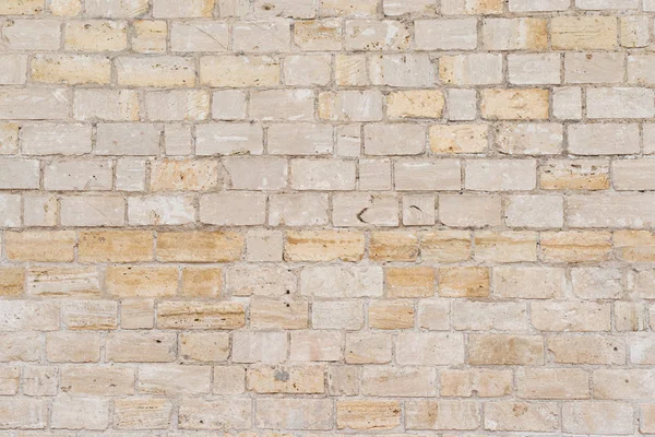 Grijze decoratieve ongelijke gebarsten stenen muur oppervlak met cement. — Stockfoto