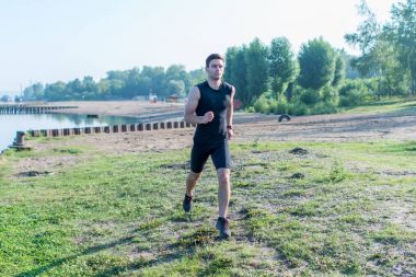 Yaz günü sabah sokakta koşu uygun atletik erkek portresi. Temiz hava açık havada eğitim