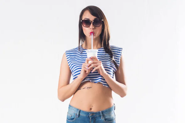 Mladá bruneta model představuje pití koktejlů studio střílel na bílém pozadí, nikoliv izolovaně — Stock fotografie