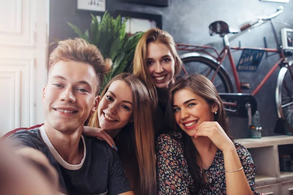 Jóvenes adolescentes sonrientes tomando selfie mientras se divierten en un bar elegante —  Fotos de Stock