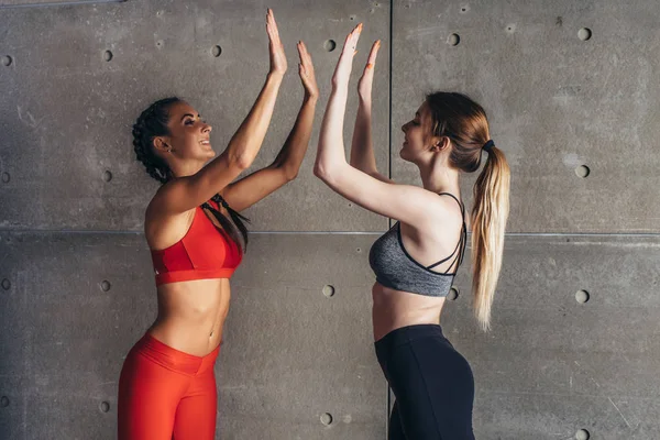 Fit young woman giving high five to friend after workout — Stock Photo, Image
