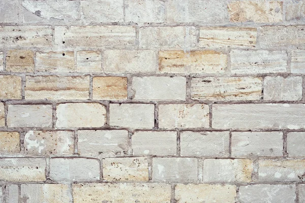 Part of a uneven stone wall with cement — Stock Photo, Image