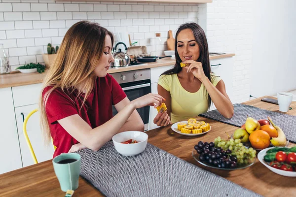 Dos amigas desayunando en la mesa en la cocina . —  Fotos de Stock