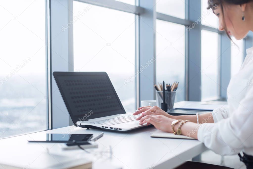 Side view portrait of woman working in home-office as teleworker, typing and surfing internet, having work day.