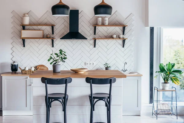 Moderno interior de luz nueva de cocina con muebles blancos y mesa de comedor. — Foto de Stock