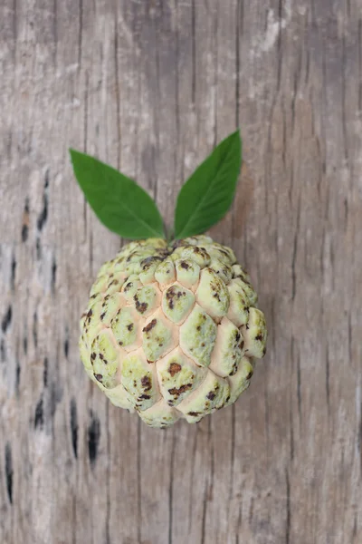 Fresh custard apple or sugar apple on old wooden floor. — Stock Photo, Image