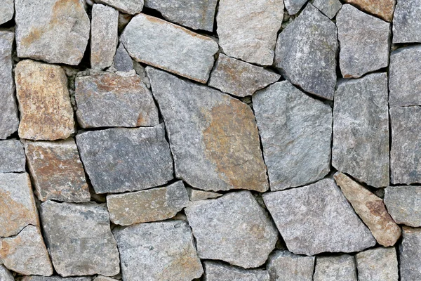 Gammal stenmur konsistens i vittrade och har naturliga ytor. — Stockfoto