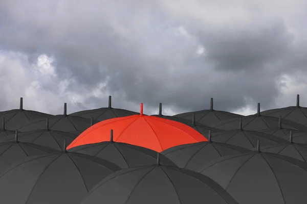 小红伞和包围起来，一把黑色雨伞. — 图库照片