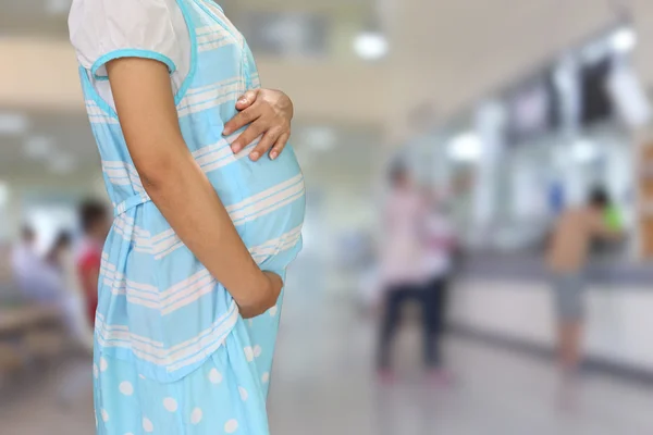 Pregnant women wear blue maternity clothes.