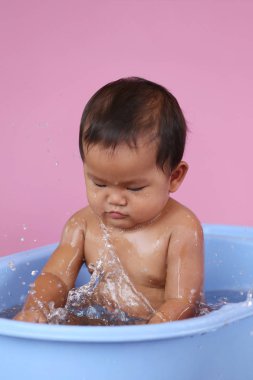 Asya bebek ile mavi bir yüzme havuzunda mutlu banyo.