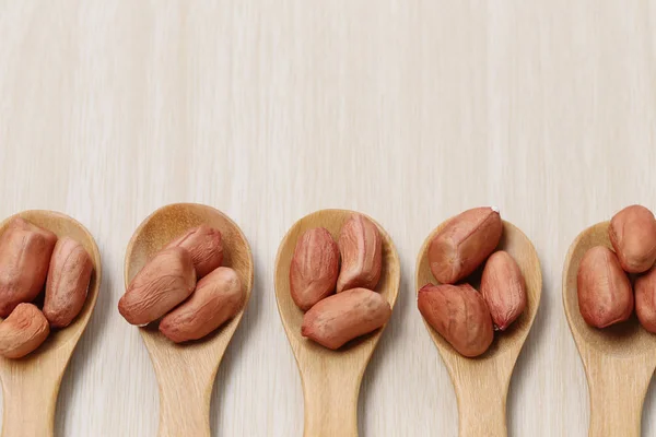 Peanut in wooden spoon on wood background. — Stock Photo, Image