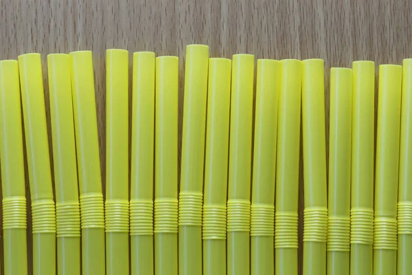 Drink tube of yellow color in abstract background. — Stock Photo, Image