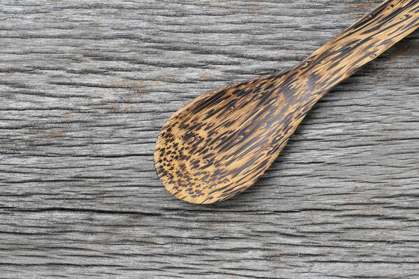 Wooden spoon on brown wood floors.